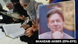 Supporters in Pakistan hold a photo of imprisoned former Prime Minister Imran Khan (file photo).