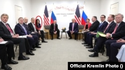 Russian President Vladimir Putin meets with U.S. President Donald Trump on the sidelines of the G20 summit in Osaka, Japan, on June 28, 2019. Daria Boyarskaya is highlighted in the background.