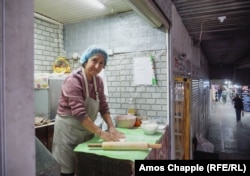 Lida Mkrtchian prepares a jingalov hat in her booth at the entrance to the Barekamutyn (Friendship) subway station.