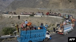 Trucks transporting Afghan refugees with their belongings are seen along a road toward the Pakistan-Afghanistan Torkham border, following Pakistan's government decision to expel people illegally staying in the country.