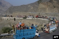 Trucks transporting Afghan refugees with their belongings travel a road toward the Pakistan-Afghanistan Torkham border crossing on November 3, 2023, following Pakistan's government decision to expel people illegally staying in the country.