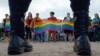 Police officers watch as people wave rainbow flags during a gay pride rally in St. Petersburg in 2017.