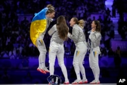 Kharlan (left) and her teammates celebrate their gold medal at the 2024 Paris Olympics on August 3.