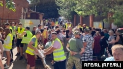 At a distribution center for humanitarian aid in the southern Russian city of Kursk, workers load and unload supplies for people who have fled ahead of Ukraine's incursion into the region. 