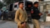 An Afghan national who according to police was undocumented is seen with his hands tied after he was detained and shifted to a holding center in Karachi, Pakistan, on November 1.