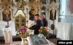 Orthodox parish priests Teodor Pelin (left) and Vasile Enache at the St. Archangel Michael Church in the village of Dubasarii Vechi