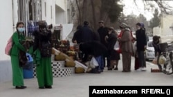 Turkmen line up outside a grocery story to buy food in the capital, Ashgabat, amid an ongoing economic crisis.