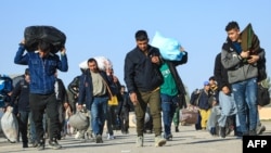 Afghan migrants deported from Iran arrive in the border town of Islam Qala in western Afghanistan.