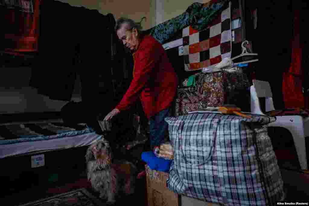 Another IDP from the town of Bakhmut, Yulia, enjoys some playtime with her dog in the shelter. The 76-year-old lay wounded for three days after receiving a gunshot wound in her arm. Ukrainian soldiers who came to her aid told her that if she had stayed two more days, she would have died. &nbsp;