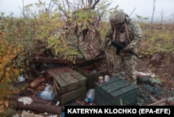 A Ukrainian soldier of the 65th Separate Mechanized Brigade inspects the former position of Russian troops, now named "X Position," near Robotyne, Zaporizhzhya region, on November 4, 2023.