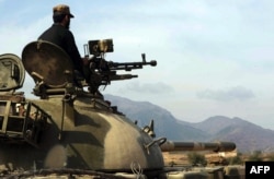 A Pakistani paramilitary soldier sits on a tank in the restive area near Kohat in Khyber Pakhtunkhwa. (file photo)