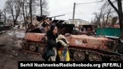 Bucha resident Olha, who told RFE/RL, "When my father built our house, he made a basement underneath and told us, 'If anything happens, this is your bomb shelter,'" she recalled. "When [the invasion] happened we looked outside and saw tanks already in our yard shooting. We rushed to that basement and sat tight for seven hours. The tank tracks screeched and there was a terrible battle." After two tanks hid behind her house, Olha says, "we had already said goodbye to life.... Then we came out and saw this terrifying picture. Like some kind of Armageddon."