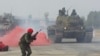 A Taiwanese soldier reacts as a tank approaches during January military drills simulating a military invasion. 