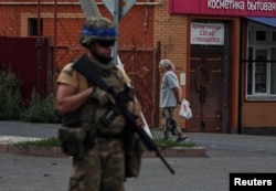 A Ukrainian soldier patrols an area of Sudzha, Kursk region, Russia, on August 16.