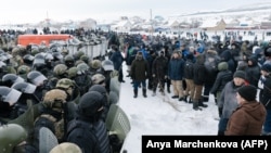 Riot police disperse protesters in the town of Baimak on January 17.