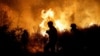 Firemen in southern Israel work to put out a blaze started after Hamas and other militants launched coordinated attacks across the border from Gaza on October 7, 2023.