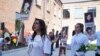 Local residents marched on September 1 in the yard of School No. 1 in Beslan, holding portraits of loved ones they lost 20 years ago in the massacre.