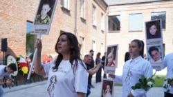 Local residents marched on September 1 in the yard of School No. 1 in Beslan, holding portraits of loved ones they lost 20 years ago in the massacre.