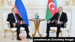 Russian President Vladimir Putin speaks with Azerbaijani President Ilham Aliyev Aliyev on June 18.