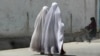 Burqa-clad Afghan women walk on a road in Kandahar. (file photo)