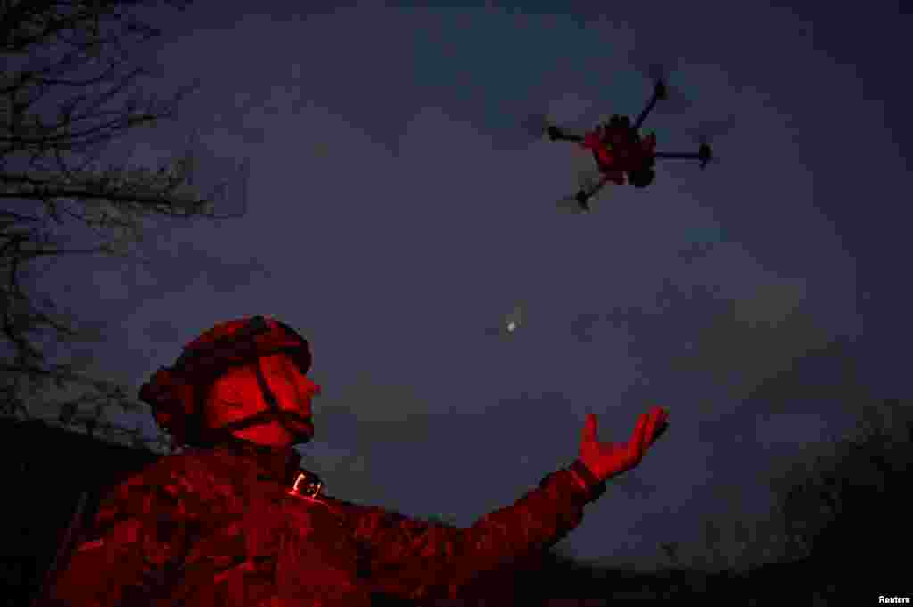 A Ukrainian soldier of the Khyzhak Brigade launches a drone at a position in a front line near the town of Toretsk, Ukraine.