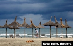 A man paints a lounge chair in Navodari, Romania.