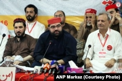 Mansoor Pashteen (left), leader of the Pashtun Tahafuz Movement, and Aimal Wali Khan (center), the provincial president of the Awami National Party, hold a debate in Peshawar on August 16 about the Taliban's return.