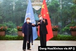 Chinese Foreign Minister Wang Yi (right) meets with United Nations High Commissioner for Human Rights Michelle Bachelet in Guangzhou in May.