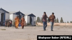 Young Afghan men walk toward the crossing into Iran in the western Afghan province of Herat. (file photo)