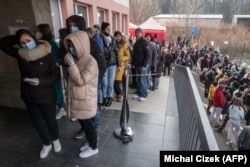 Ukrainian refugees queue to file for residence permits at Prague's foreigner police headquarters on March 2, 2022.