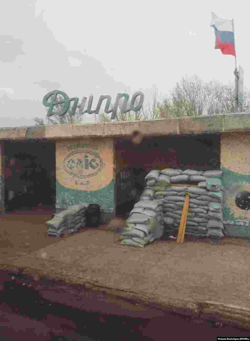 A Russian checkpoint in the occupied Kherson region in April 2022. The road to Kherson is nearly empty.&nbsp;On the way you can find broken equipment, plundered gas stations, and shell craters. Fields and forests -- what the Kherson region has always been famous for -- are now &quot;sown&quot; with the equipment of the Russian occupiers. &ldquo;People were sowing and planning the harvest.&nbsp;And now what? &rdquo;&nbsp;one local driver told RFE/RL.