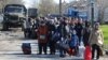 Evacuees wait to board a bus leaving the city of Mariupol in April. The data gleaned at filtration centers in Russia-controlled parts of Ukraine like Mariupol could be invaluable as the Kremlin moves forward with plans to hold so-called referendums in the occupied regions on joining Russia.