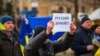 A man holds a sigm saying "Russian go home at a protest rally in the town of Henichesk in the Kherson region last month.