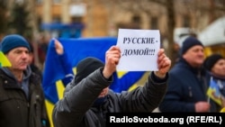 A man holds a sigm saying "Russian go home at a protest rally in the town of Henichesk in the Kherson region last month.