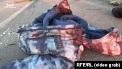 A screengrab of bloodied OMON Russian riot police gear in Bucha, near Kyiv, which was the scene of heavy fighting on February 28. Footage taken from the aftermath of the battle shows OMON gear among dead bodies and the wreckage of Russian military vehicles.