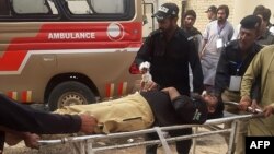 Police officers carry an injured colleague on a stretcher following a bomb blast in Sibi, a city in the southwestern Pakistani province of Balochistan, on March 8. 