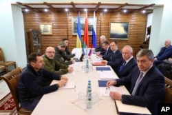 Ukrainian and Russian negotiators meet in the Belavezha forest in Belarus on March 7, 2022.