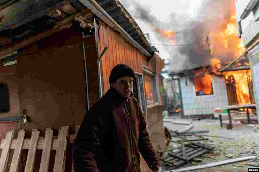 A local resident reacts as a house is on fire after heavy shelling by Russian forces in Irpin on March 6.