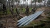 Ukrainian soldiers examine missiles abandoned by Russian troops in the village of Berezivka on April 21. Russia has suffered "significant" losses in men and equipment in the eight weeks of war.