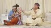 Two musicians perform a "music-less song" at a wedding party in Herat Province.