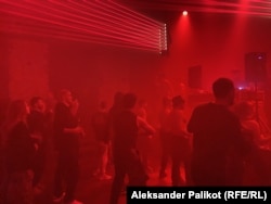 Young Kyiv residents enjoy a generator-powered rave party in the city's Podil district.