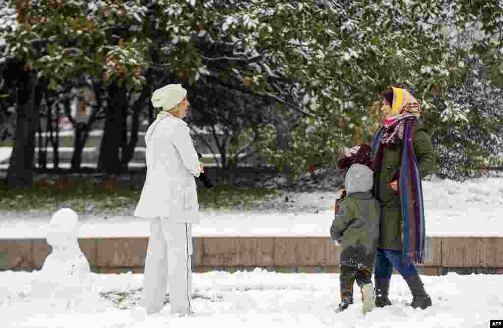 Women chatting in a park after a snowfall in Tehran on December 24.&nbsp; A Voice of America report cites a Washington-based rights group as claiming patrols by the morality police disappeared from Tehran&#39;s wealthier neighborhoods in recent weeks.&nbsp;