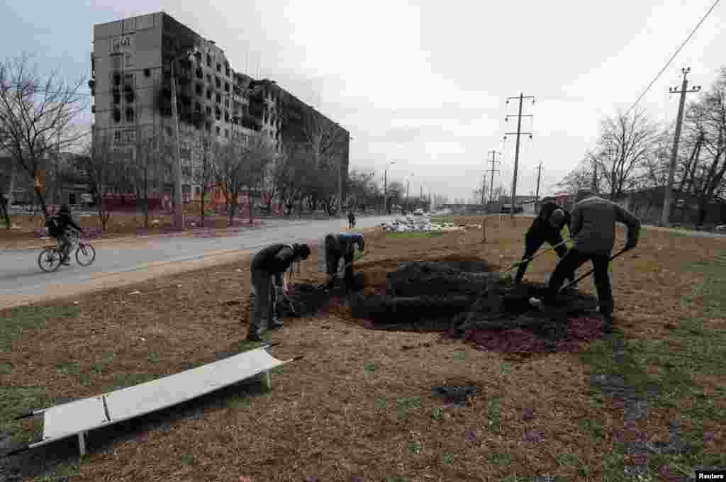 Graves are prepared for victims killed during Russia&#39;s assault on the city. Many corpses have been left where they fell for long periods because it was too dangerous to collect and bury them.