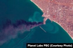 In this satellite photo from Planet Labs PBC, smoke rises after an attack that Ukraine's navy said sank a large Russian landing ship in the port city of Berdyansk, Ukraine, on March 24, 2022.