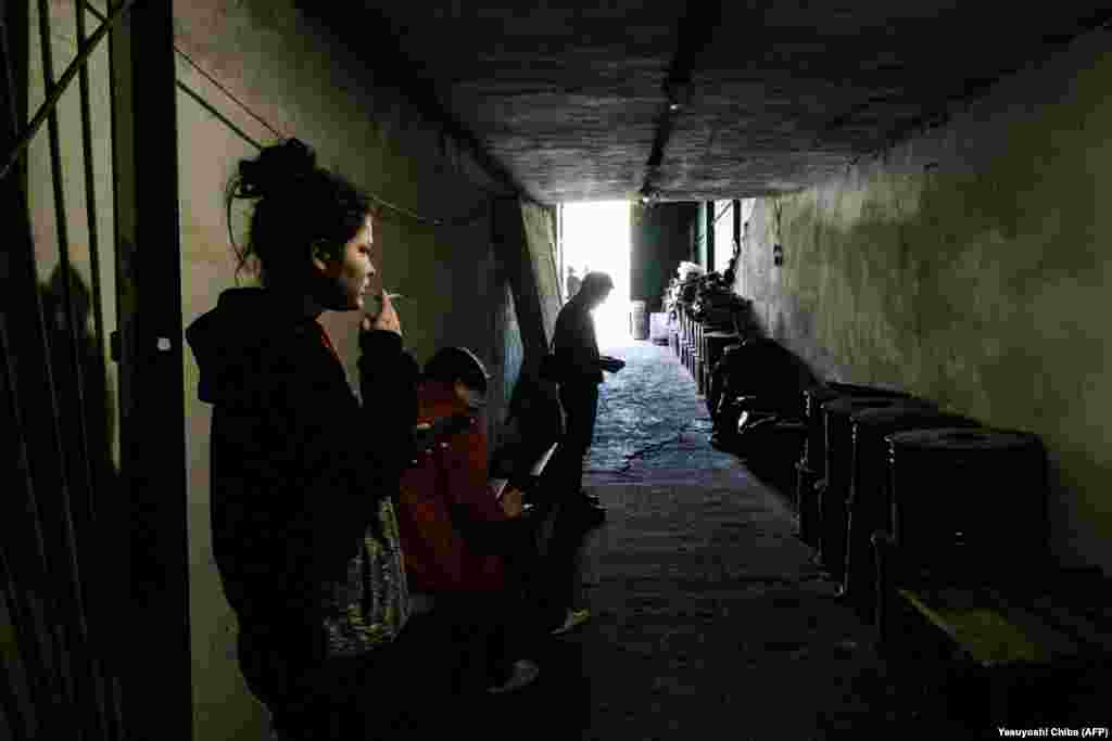 A woman smokes in the safety of a bunker that is serving as a bomb shelter in Severodonetsk on April 27.&nbsp;