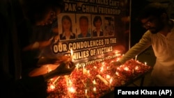 Mourners pay tribute at Karachi's Confucius Institute on April 28 to those killed by a suicide bomber. 