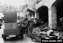 A resident of Vukovar, 100 miles northwest of Belgrade, removes the remaining possessions from his ruined home on November 28, 1991. More than 2,000 people were killed during the three-month-long siege of this Croatian town.