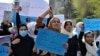 In March 2022, Afghan women and girls shout slogans demanding the reopening of high schools for girls during a demonstration in front of the Ministry of Education in Kabul. 