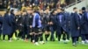 Kosovar players walk off the pitch in Bucharest.