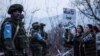 Protesters stand in front of Russian peacekeepers on the road outside Stepanakert, the de facto capital of Nagorno-Karabakh, on December 24, 2022. 